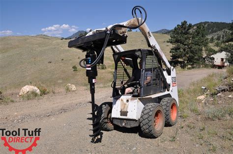 digging a hole with a skid steer|post hole auger.